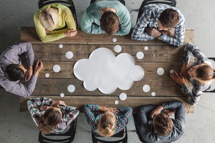 A group of people around a table brainstorming